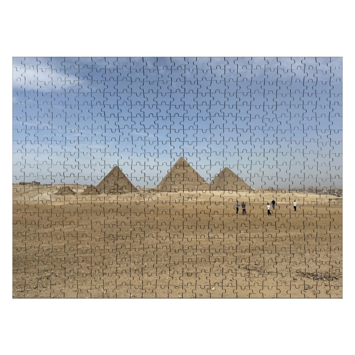 Full color photograph of the Pyramids of Giza with golden desert sands and blue sky in the background