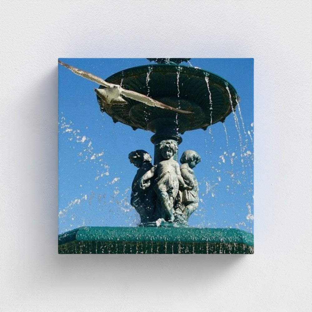 eco-friendly recycled canvas print featuring a seagull flying over an ornate fountain against a clear blue sky