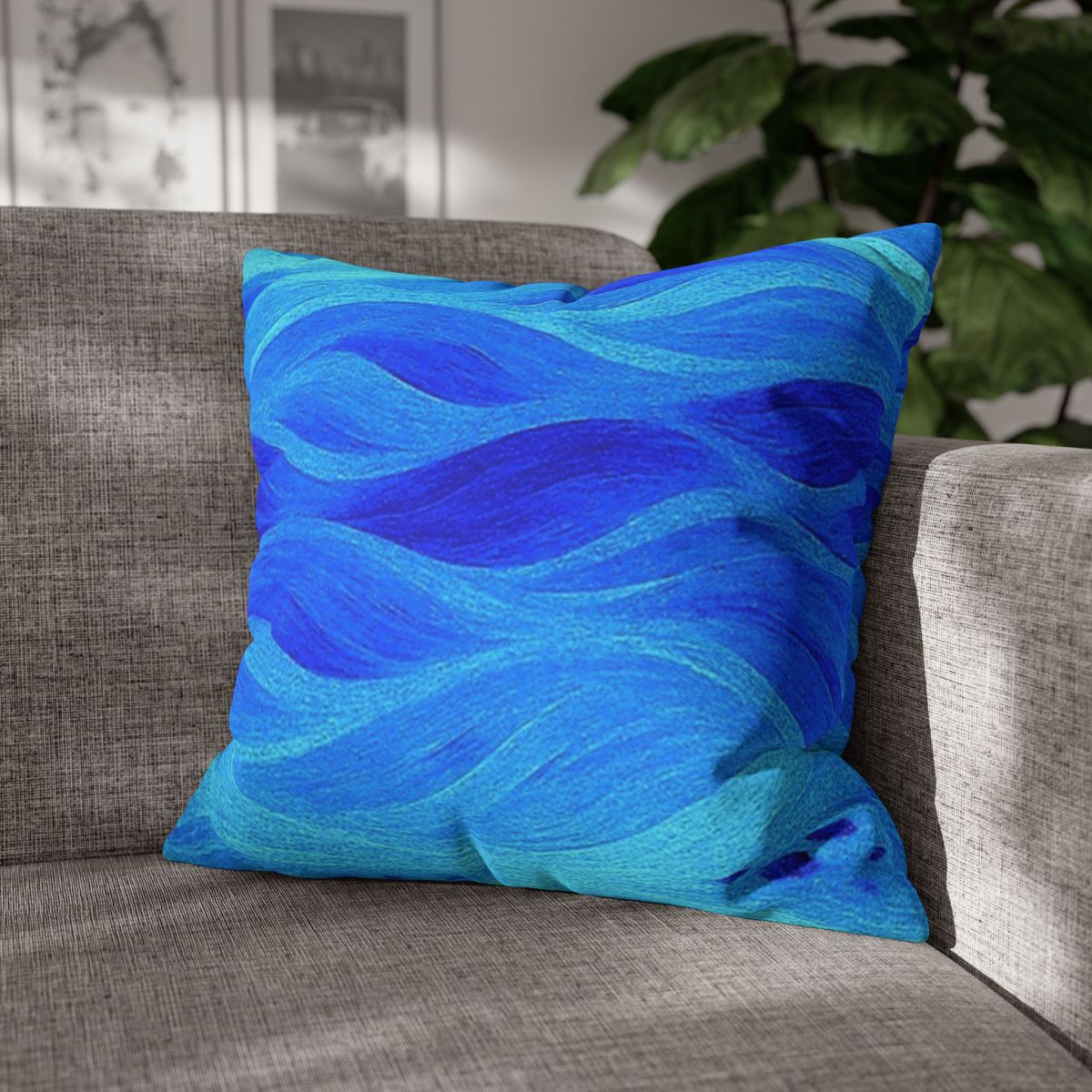 20" × 20" Abstract Wave pillowcase in Azure placed in the corner of a gray sofa