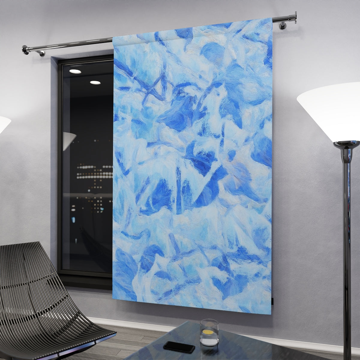 Cool blue curtain variant with crisp leaf abstractions hanging in a contemporary nighttime space, gently illuminated by floor lamps