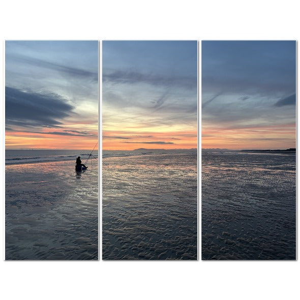 Beach Sunset Landscape Made in UK Triptych Canvas showing three panels of a lone fisherman on wet sand at sunset
