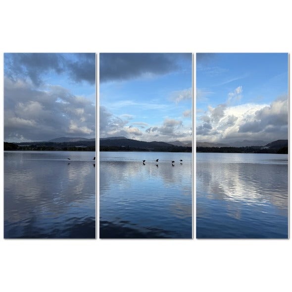 Stunning triptych of Birds Flying Over Windermere Lake Lake District Landscape with serene water reflections