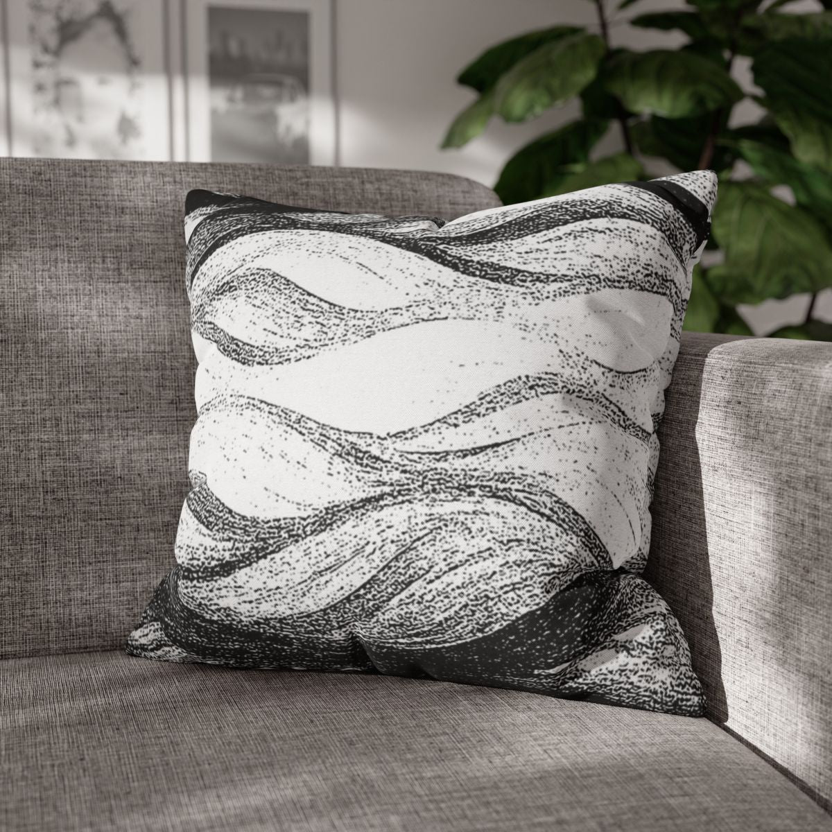 20" × 20" Abstract Wave pillowcase in Black & White placed in the corner of a gray sofa