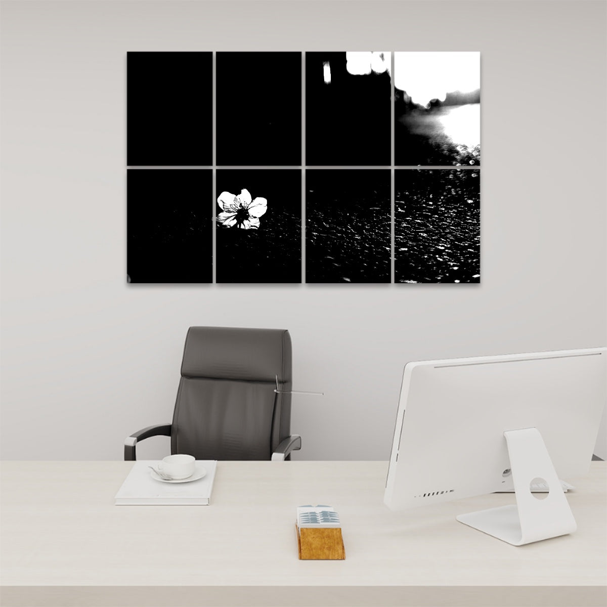 Black and white version of a delicate flower resting on asphalt, printed across 8 acoustic wall panels with high-contrast tones and textured detail.