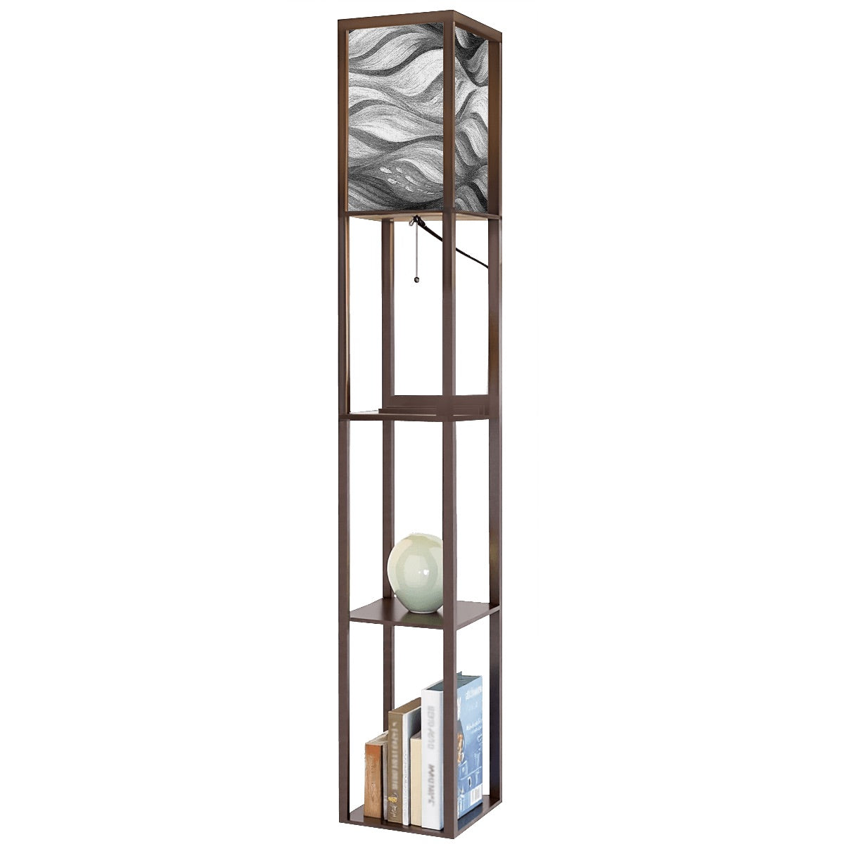 Walnut-finish wood floor lamp with three square shelves displaying a vase and books, topped by a linen cube shade in bold black-and-white wavy abstract design. A metal pull-chain switch and black power cord are visible beneath the shade.