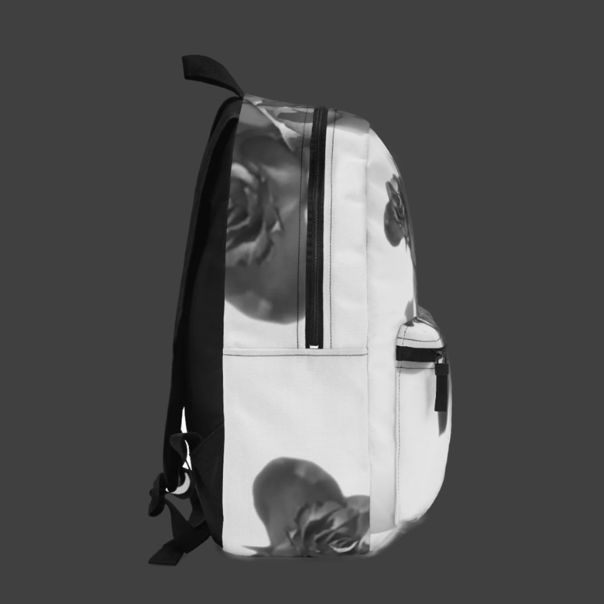 Left side of floral backpack showing black and white rose design wrapping around side panel and pocket.