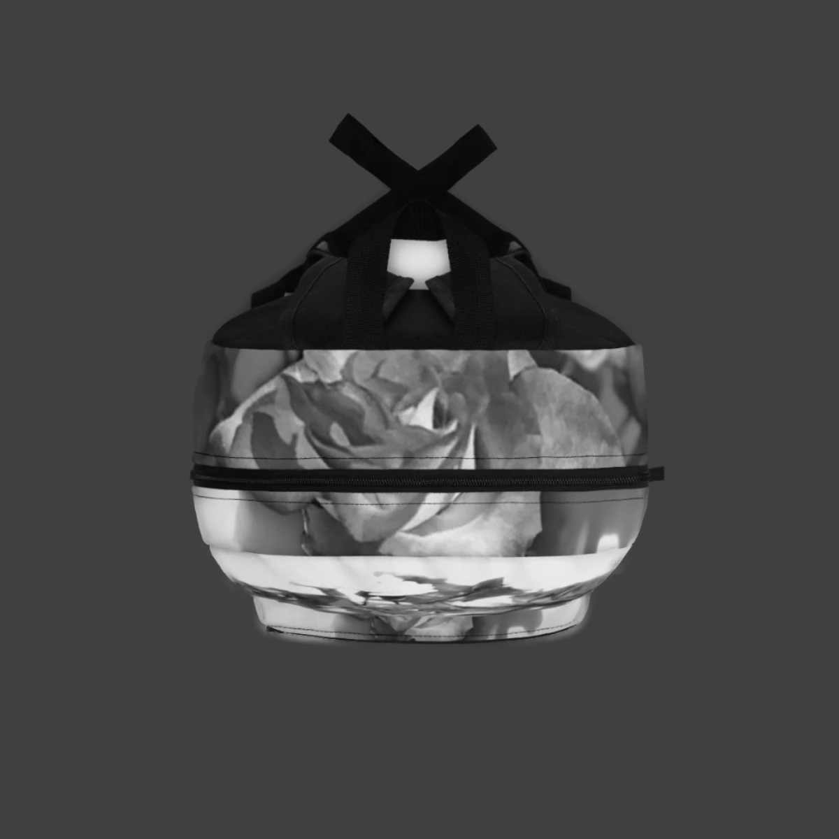 Top-down view of backpack showing rose bouquet in black and white across handle and zipper.