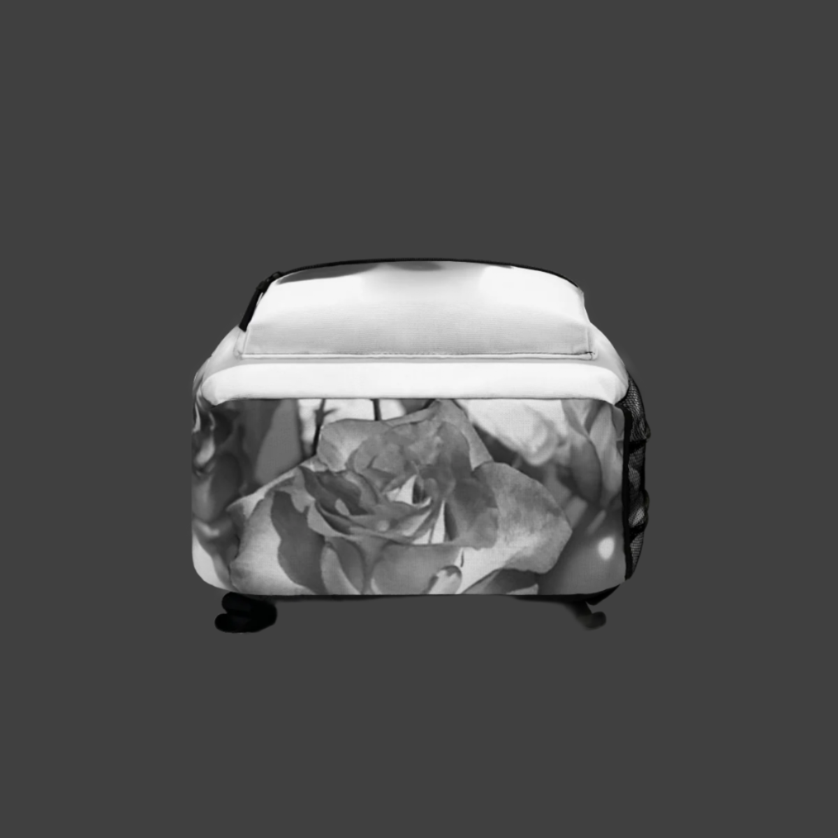 Bottom view of floral backpack featuring detailed greyscale roses and reinforced stitching.