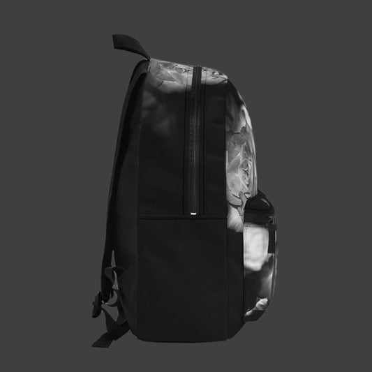 Left profile of the backpack showcasing the continued black and white floral pattern with visible padded strap and side pocket.