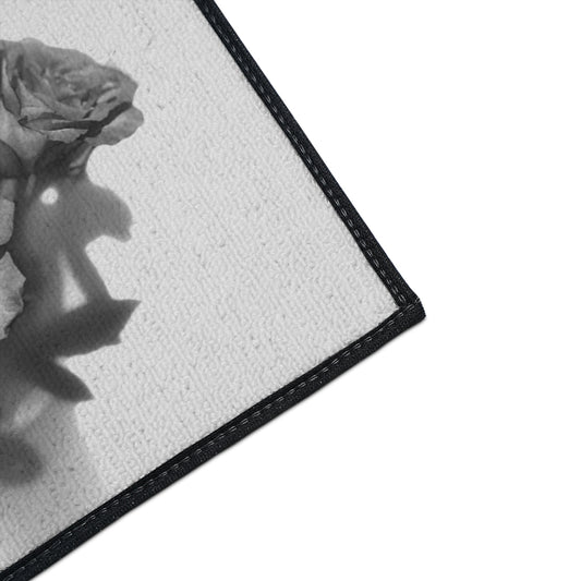 close up of the corner of heavy duty floor mat featuring black and white roses size: 18''x24''