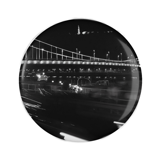 Fridge magnet featuring black and white long exposure photograph of bridge and citadel in Budapest with car and lights in bottom half