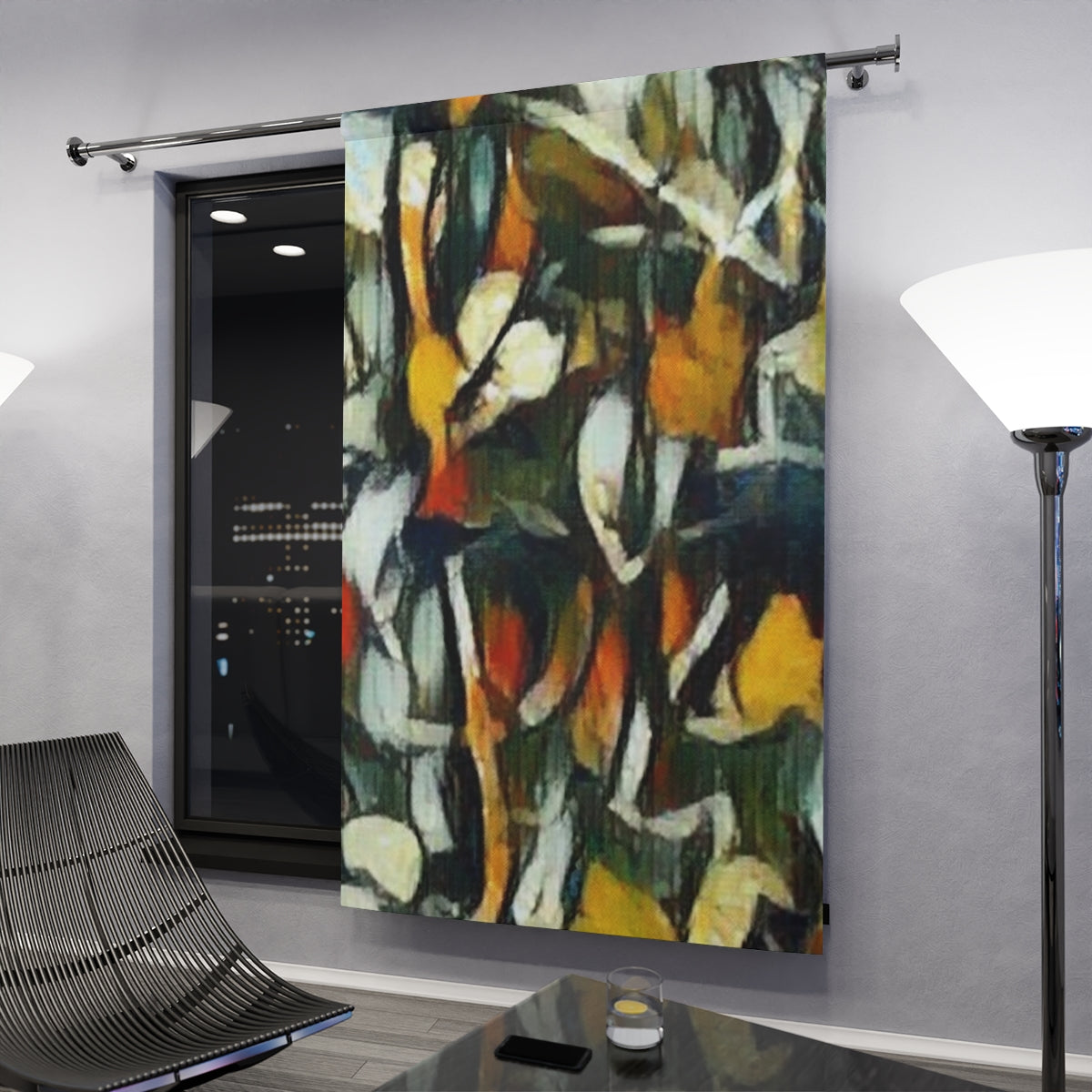 Color-rich blackout curtain with clef with jagged black and gold foliage forms glowing subtly under interior light in a modern nighttime setting