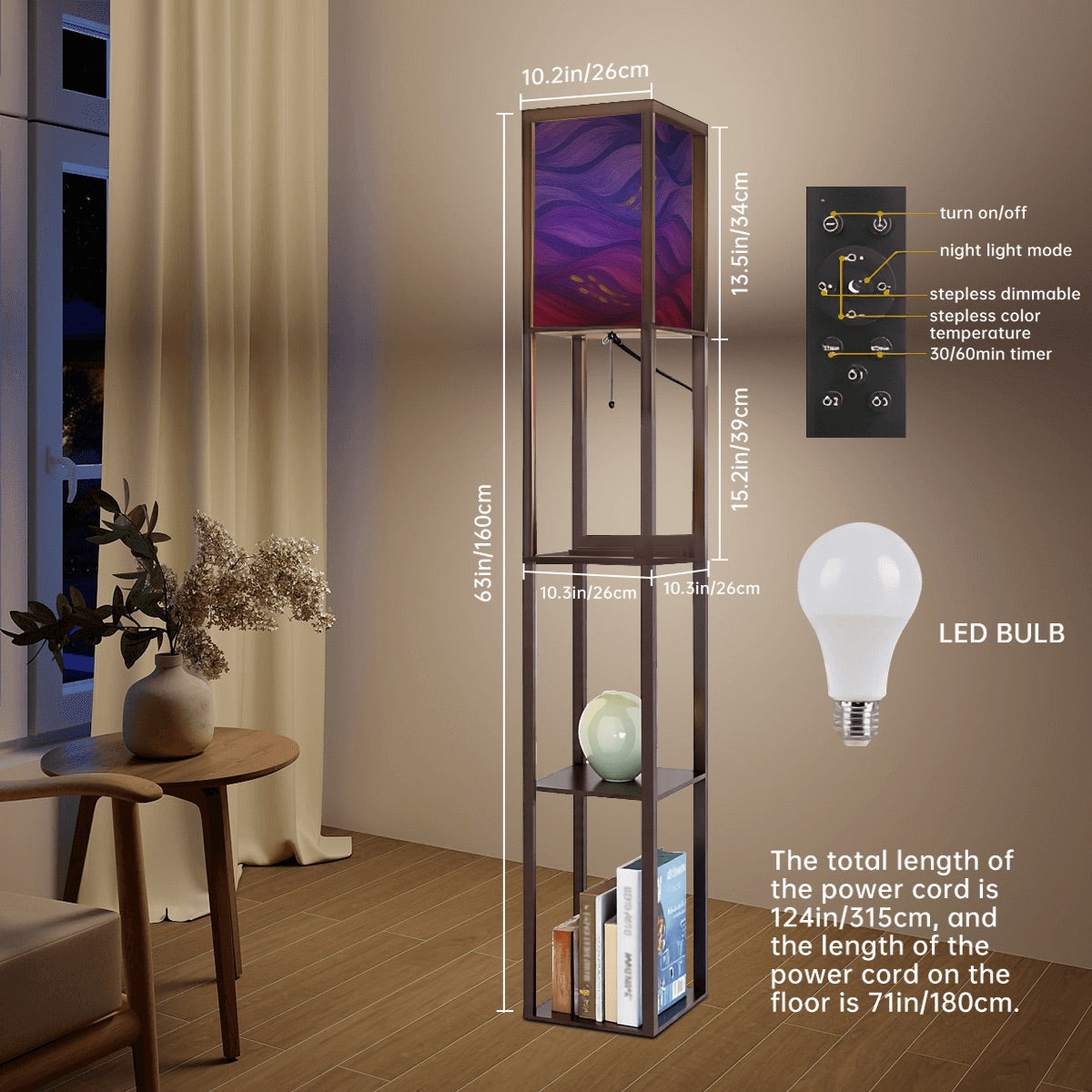 Walnut-finished wood floor lamp with three open square shelves—one holding a ceramic vase, another stacked books—and a linen cube shade featuring vibrant purple, magenta and gold wavy abstract patterns. A pull-chain switch and black power cord hang below.