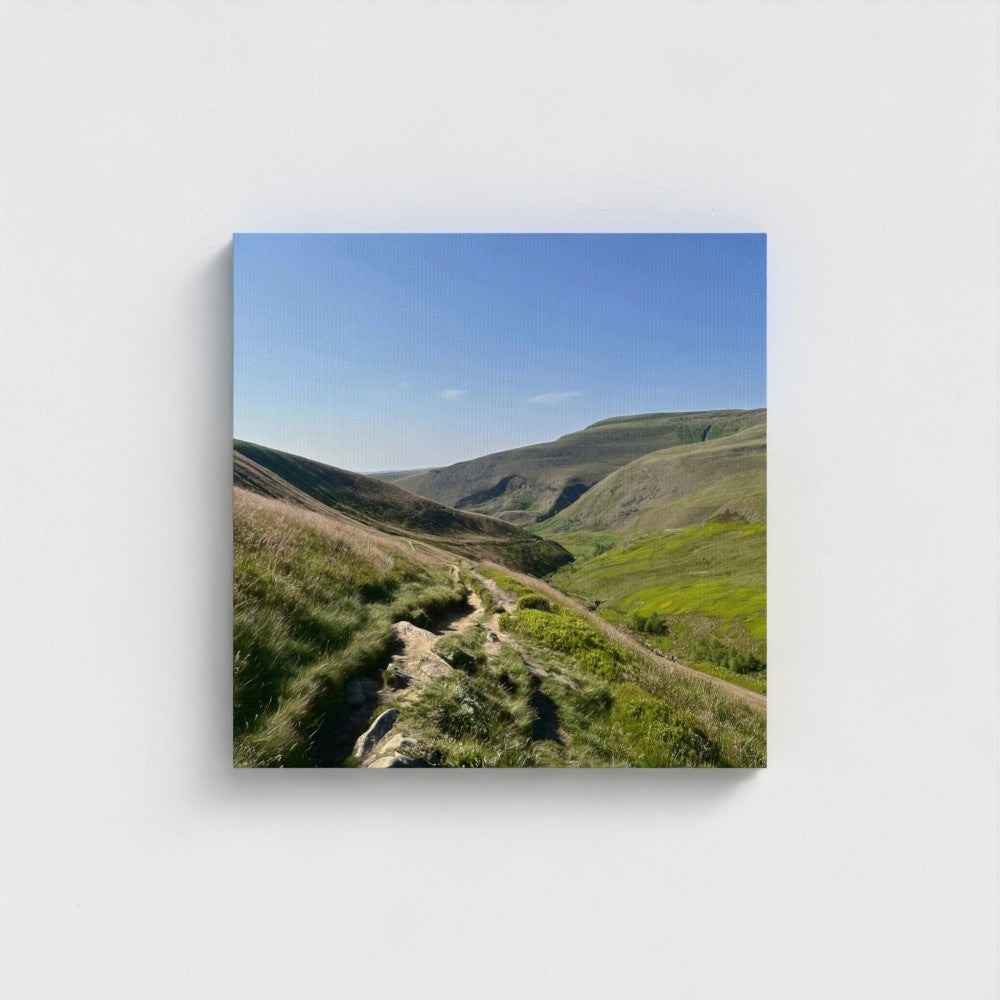 Square eco-friendly canvas print showing a rocky trail winding through green hills of the Peak District beneath a vivid blue sky