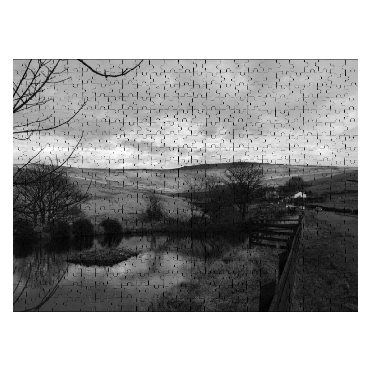 Grayscale version of the countryside puzzle with moody monochrome landscape and still water reflections.