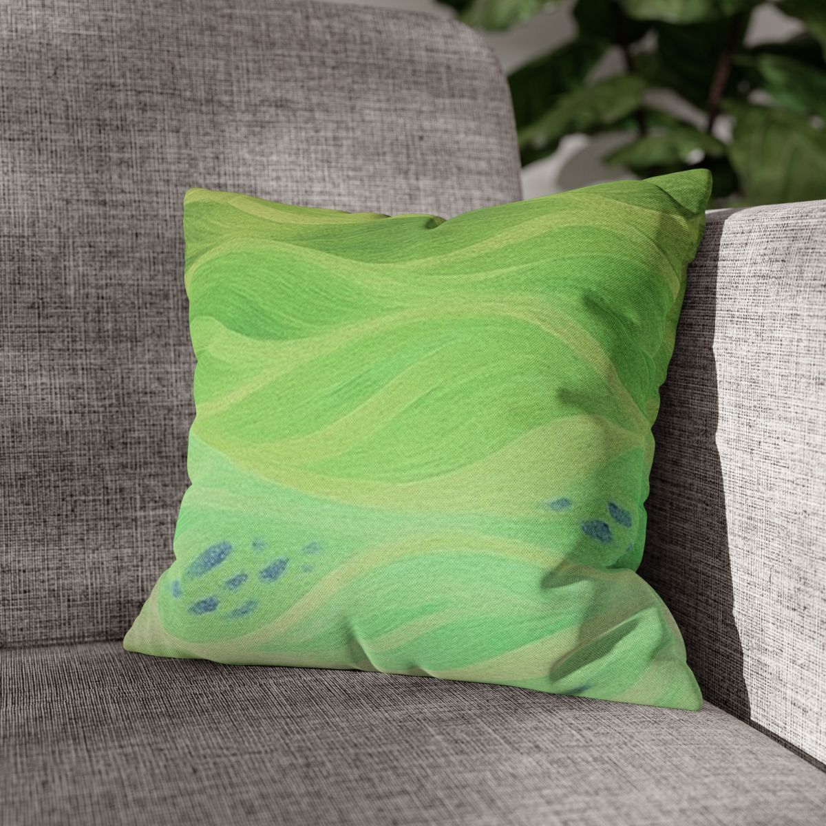 14" × 14" Abstract Wave pillowcase in Lemon & Lime placed in the corner of a gray sofa