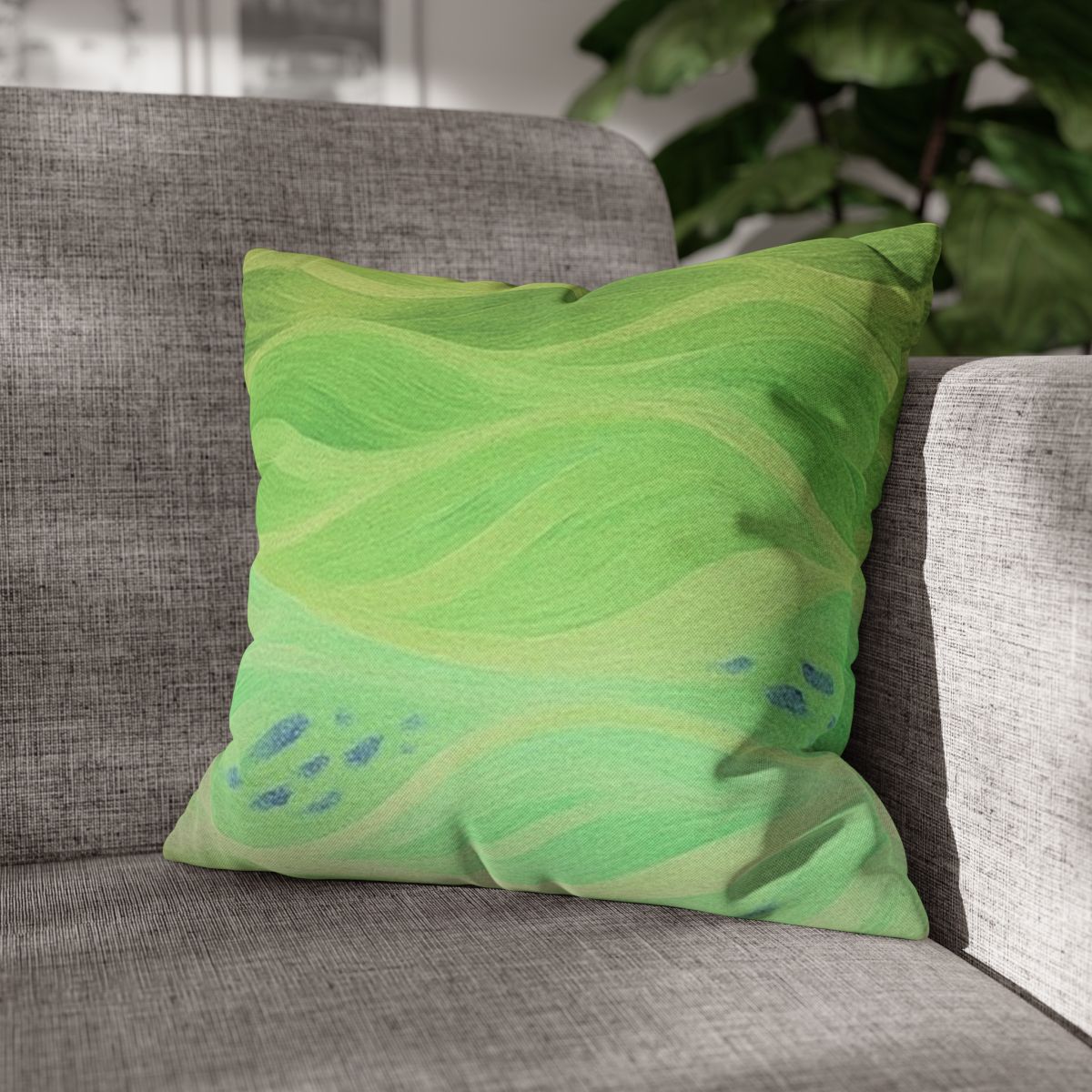16" × 16" Abstract Wave pillowcase in Lemon & Lime placed in the corner of a gray sofa
