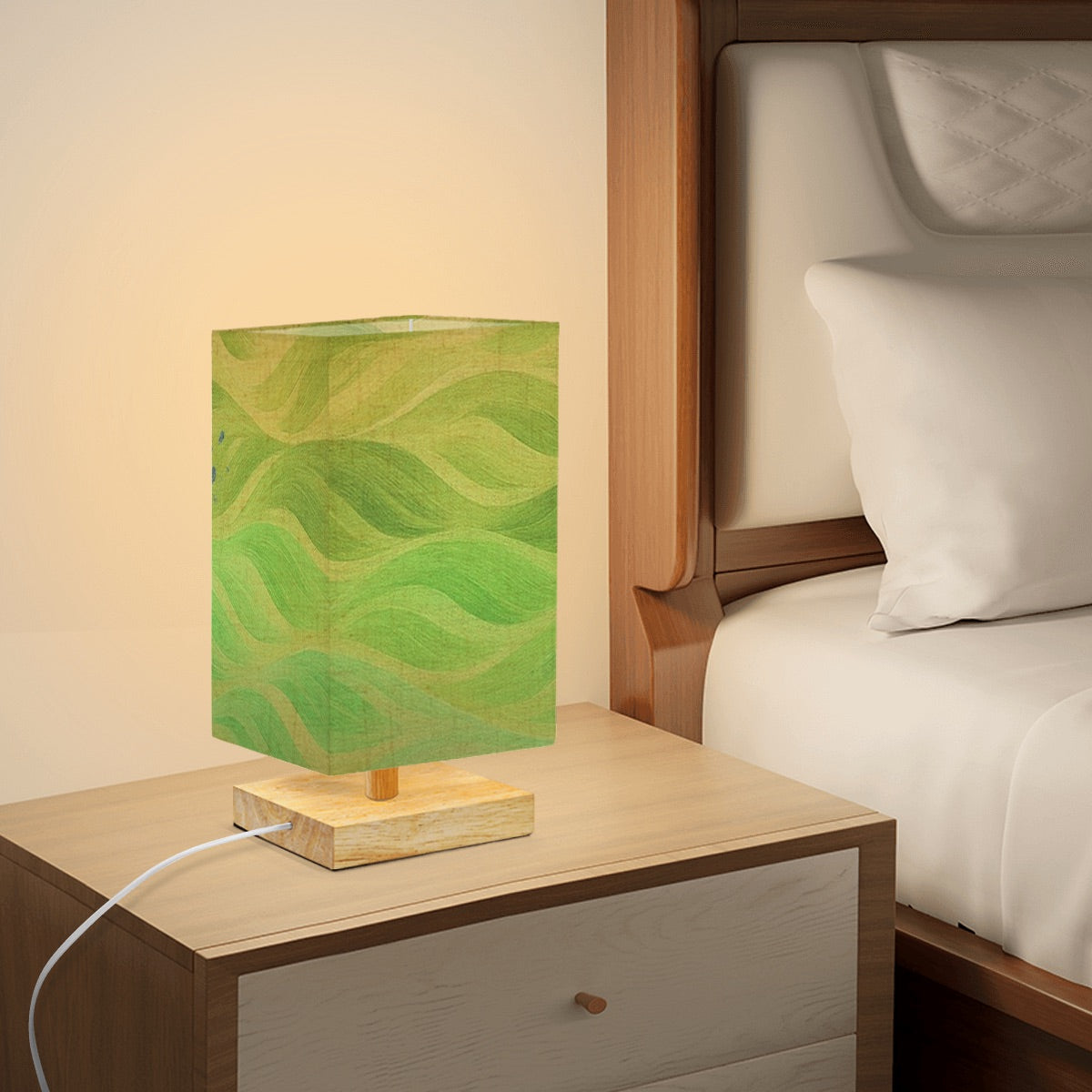 Square lamp with a dark charcoal linen shade displaying inverted gold-accented waves on a wooden base