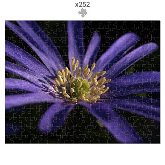 Jigsaw puzzle with a purple flower design, partially completed.