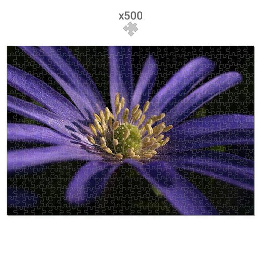 Jigsaw puzzle with a purple flower design on a black background
