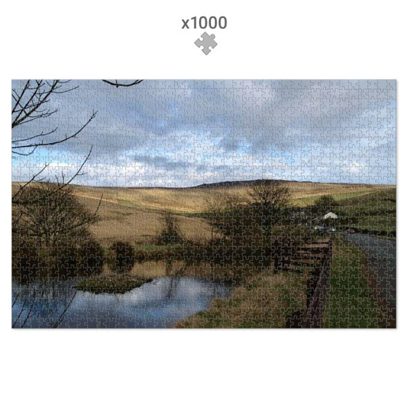Jigsaw puzzle with a scenic landscape featuring a river and hills.