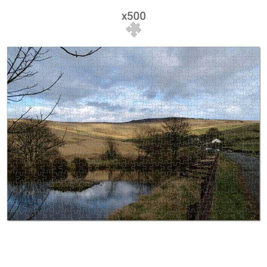 Jigsaw puzzle with a landscape design featuring a river and hills.