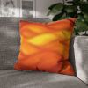 20" × 20" Abstract Wave pillowcase in Orange-Amber placed in the corner of a gray sofa