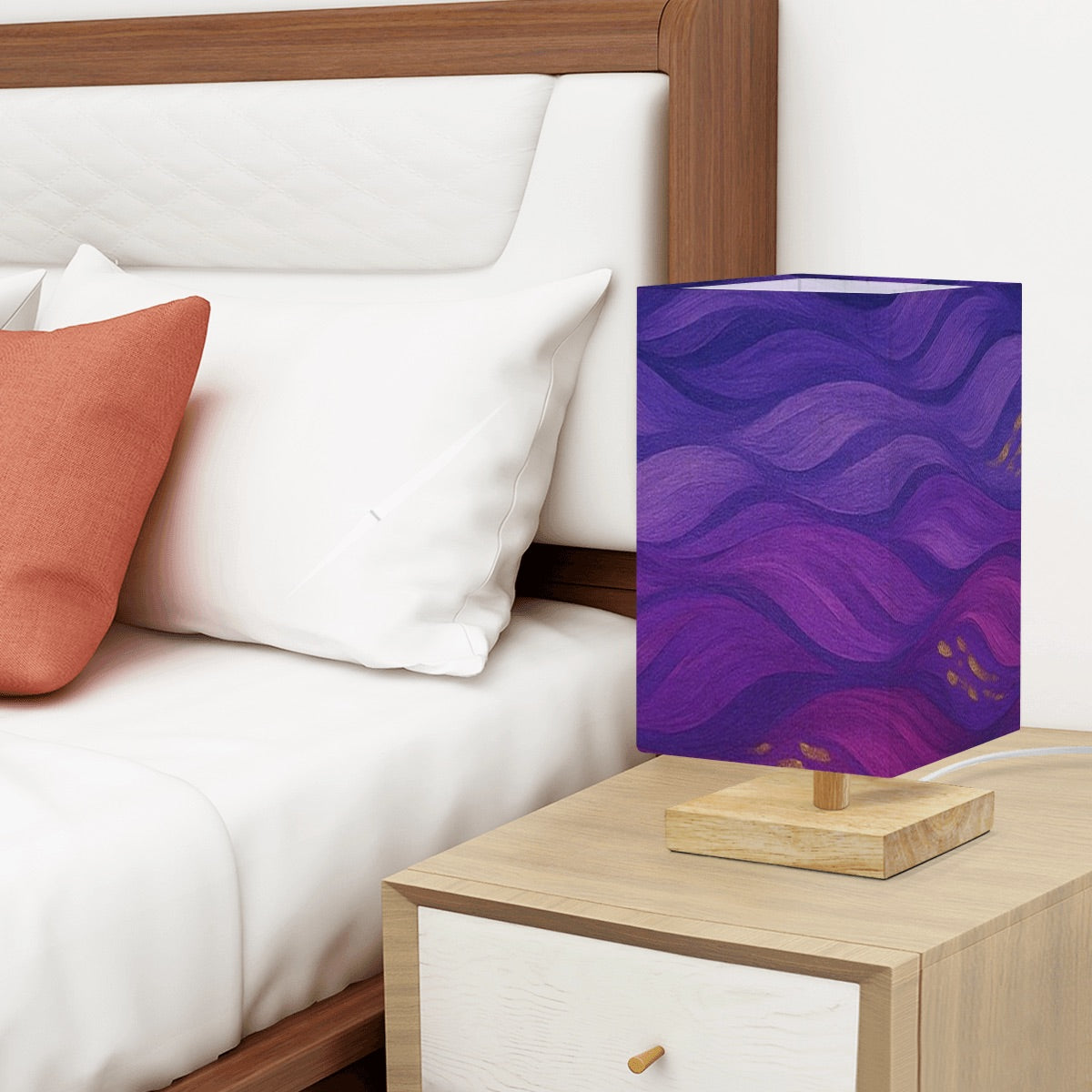 Square table lamp showing a linen shade of deep purple swirling waves with gold flecks on a rubber wood base.
