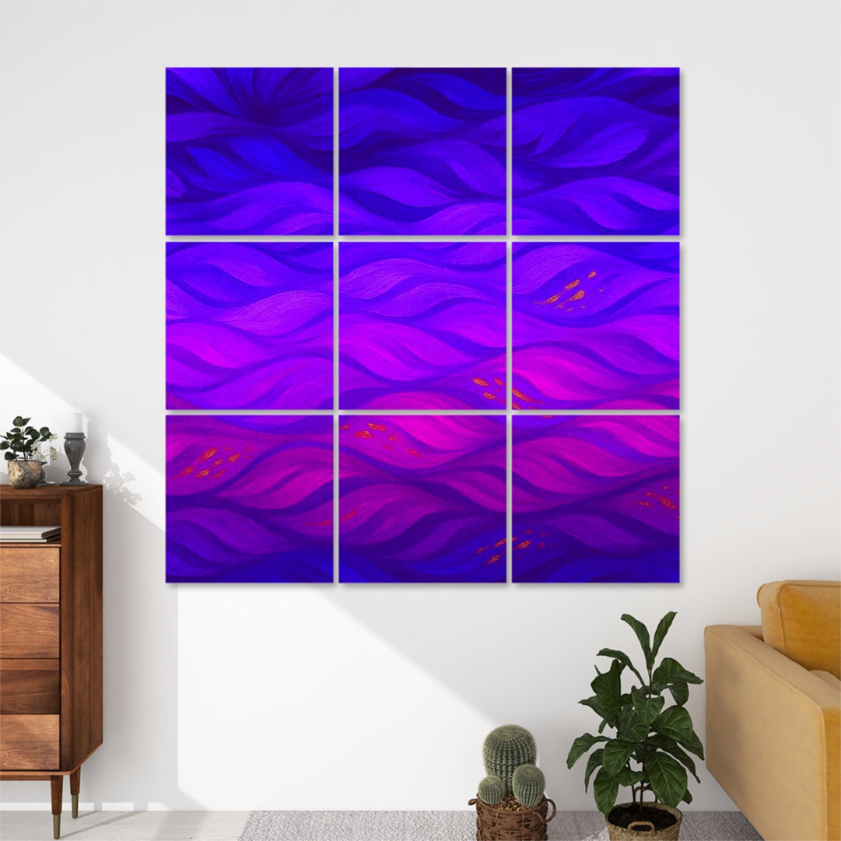 Nine panels in vivid fuchsia, cobalt and indigo strokes, mounted above a modern desk area on a neutral wall.