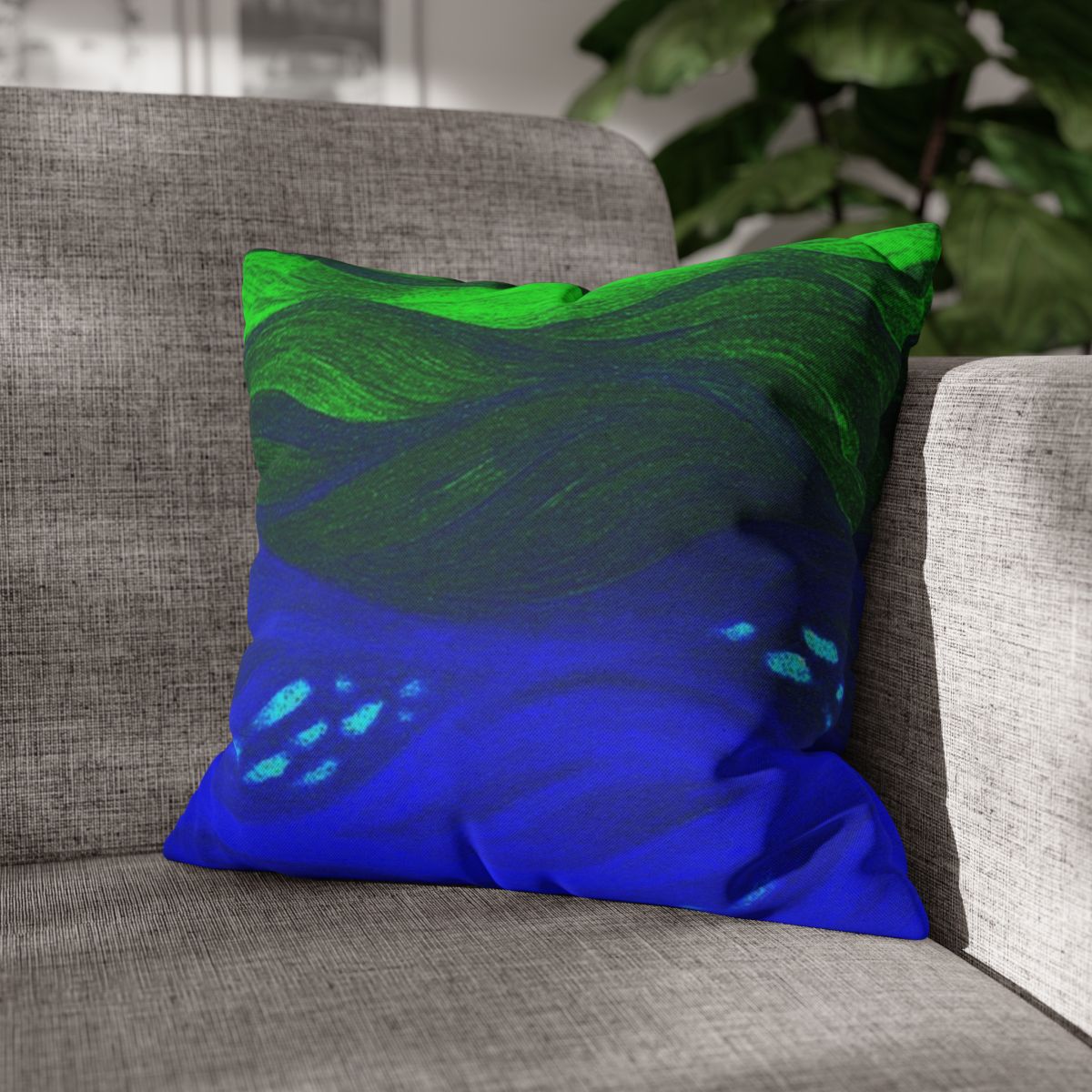 16" × 16" Abstract Wave pillowcase in Verdant Azure placed in the corner of a gray sofa
