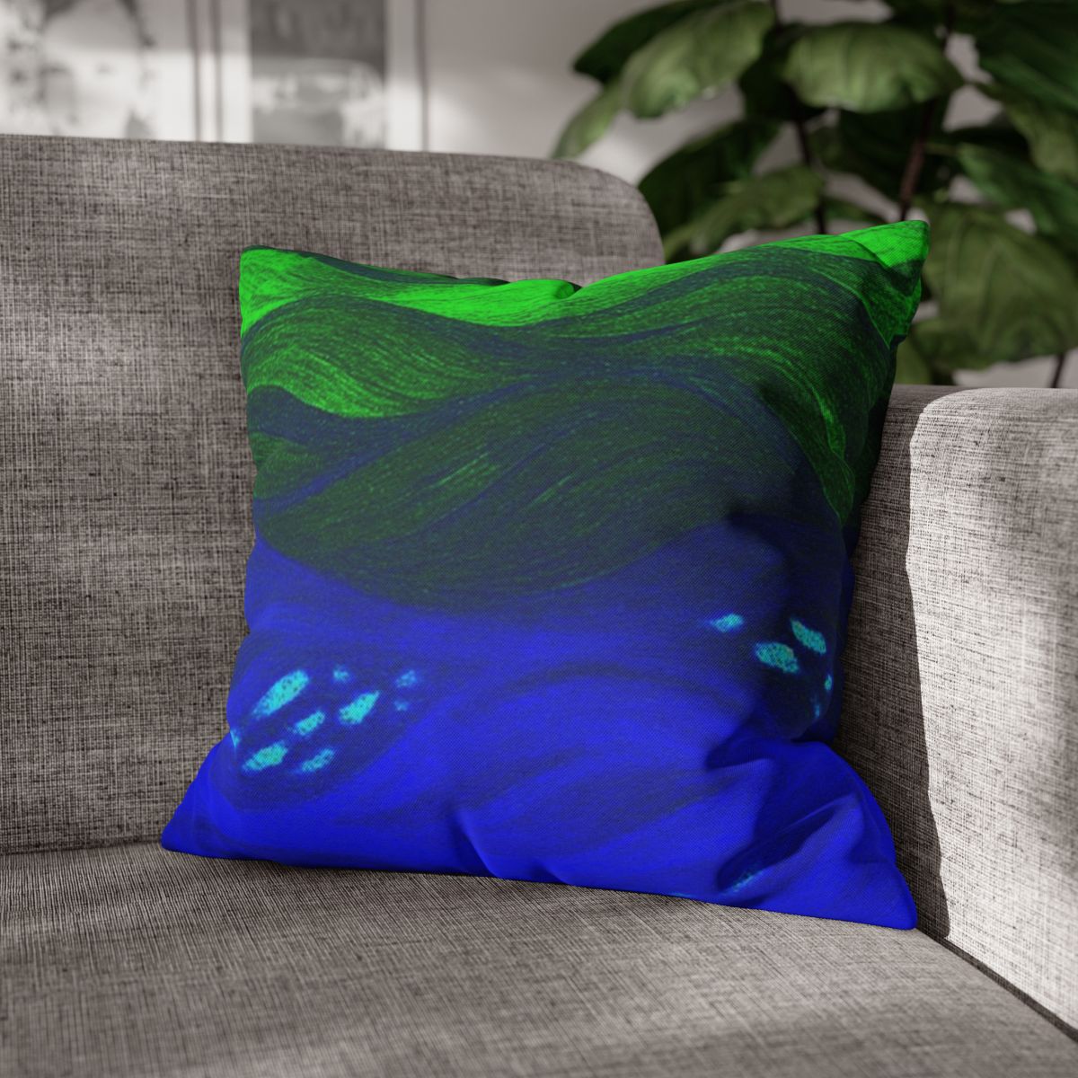 18" × 18" Abstract Wave pillowcase in Verdant Azure placed in the corner of a gray sofa