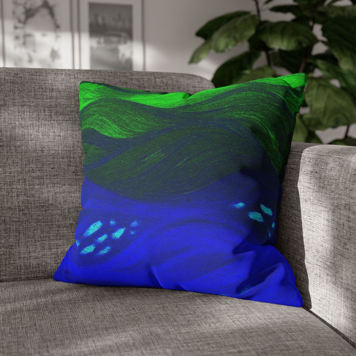 20" × 20" Abstract Wave pillowcase in Verdant Azure placed in the corner of a gray sofa