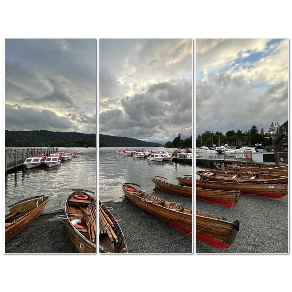 Windermere Lake District Landscape made in UK Triptych Canvas showing wooden rowboats on a lakeshore under dramatic cloudy sky