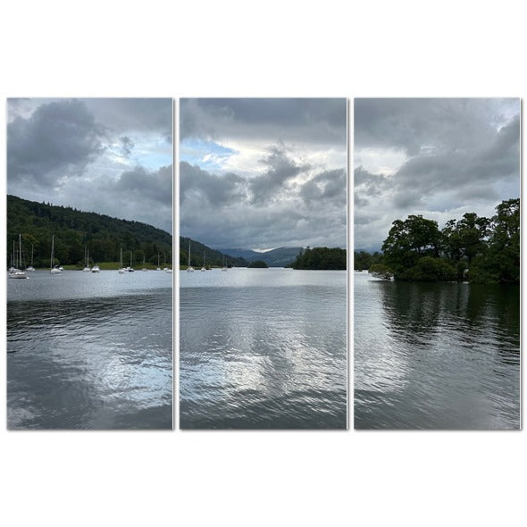 Windermere Lake Landscape Made in UK Triptych Canvas featuring wooden rowing boats and motorboats on a calm lake under cloudy sky