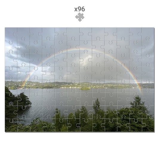 Landscape with Lake and Rainbow Jigsaw Puzzle showing a scenic view of a lake with greenery and a full rainbow