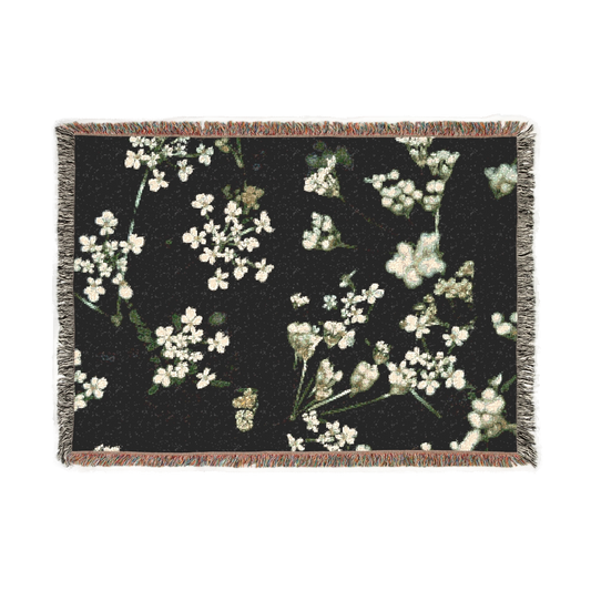 woven blanket featuring white little flowers on black background
