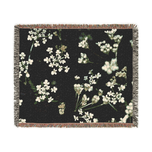 woven blanket featuring white little flowers on black background